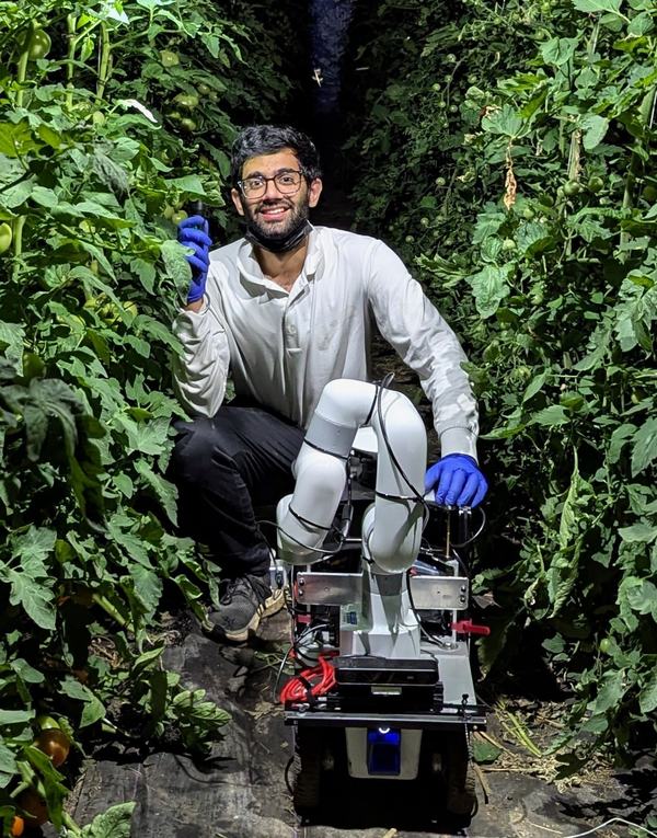 Kulbir Singh Ahluwalia with a mobile manipulator in a field